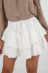 White ruffled skirt worn by a person on a white background