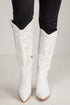 White knee-high boots with black pants on a light background