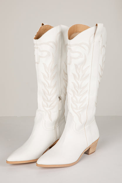 White quilted knee-high boots on a light gray background