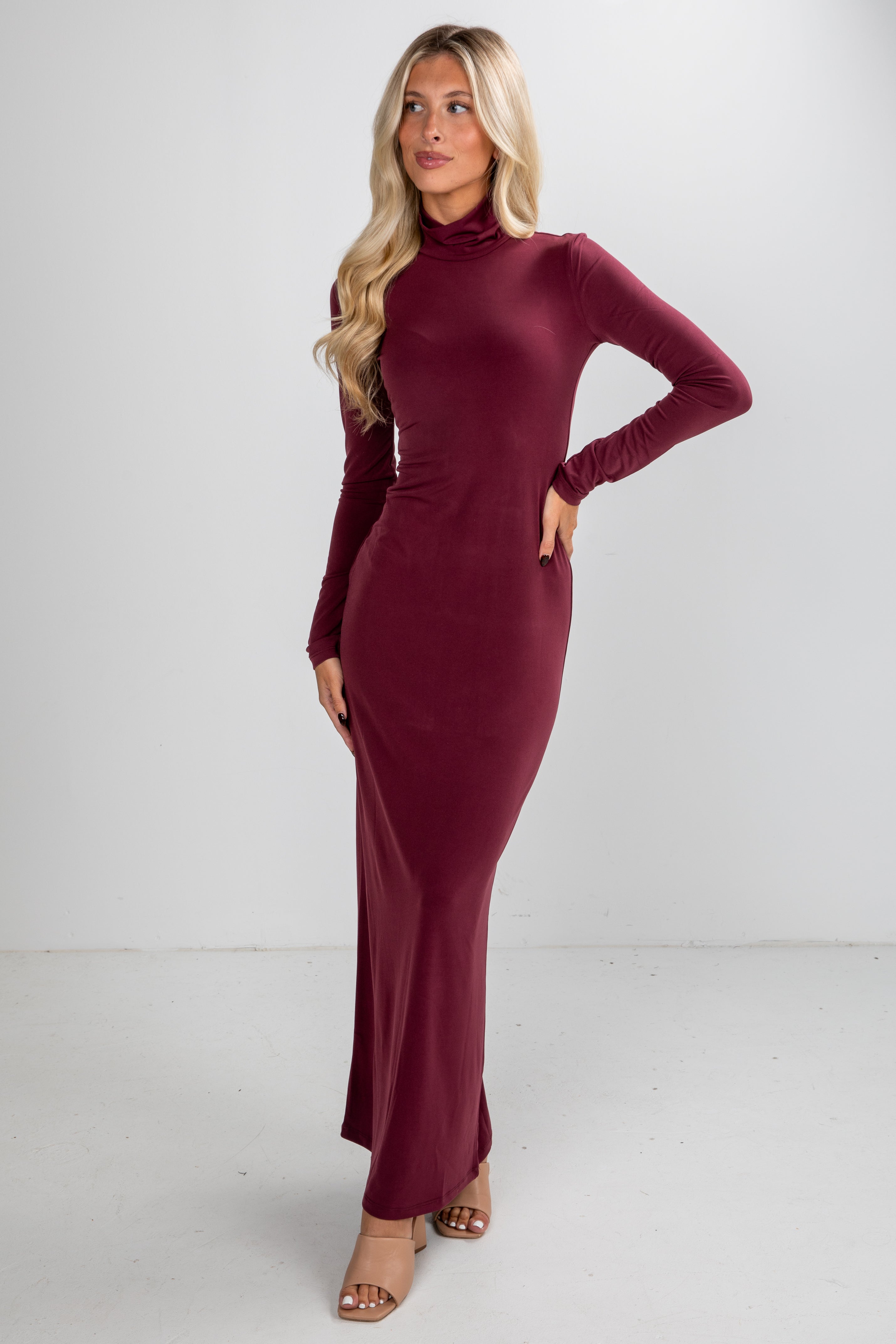 Woman wearing a burgundy dress against a white background