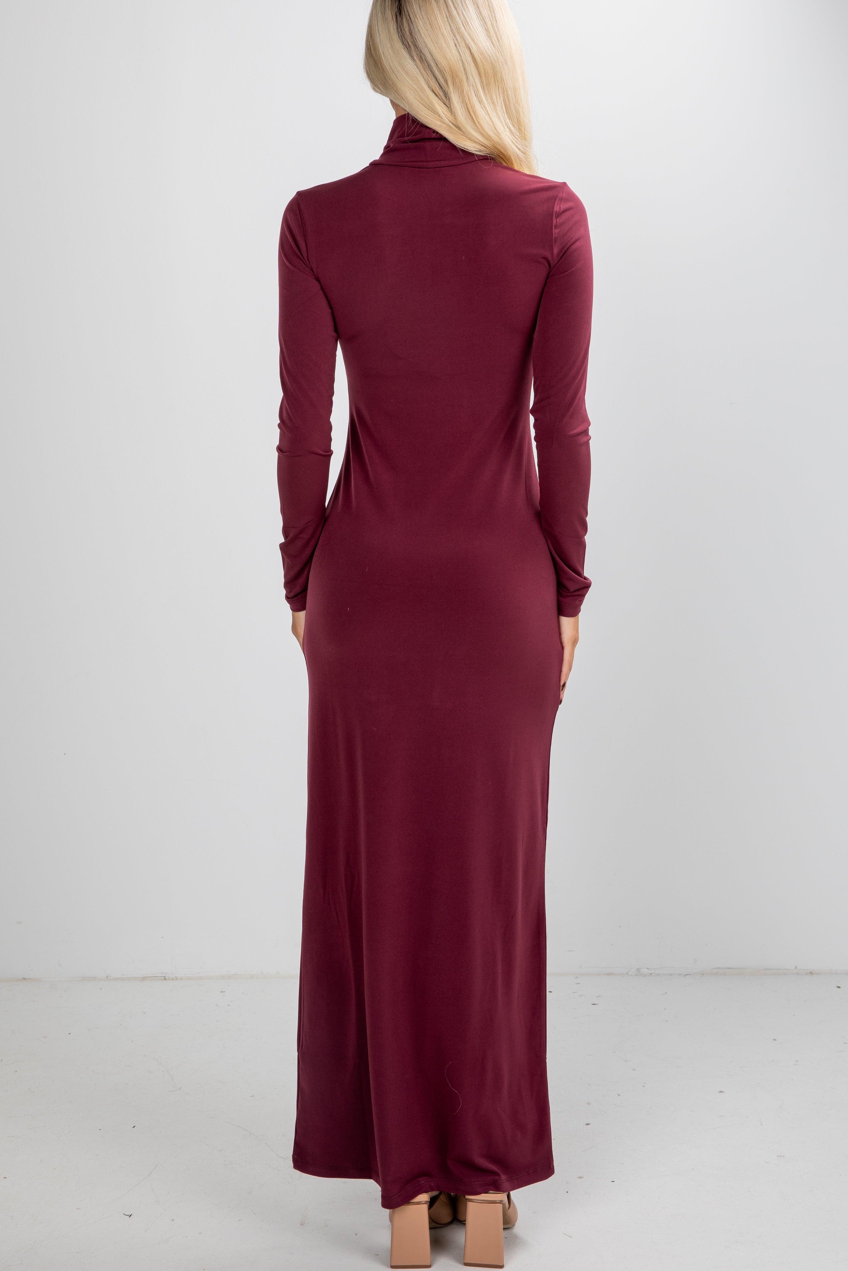 Burgundy long-sleeve dress worn by a person on a white background