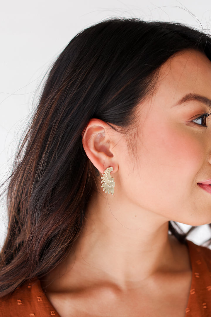 Gold Wing Earrings on model