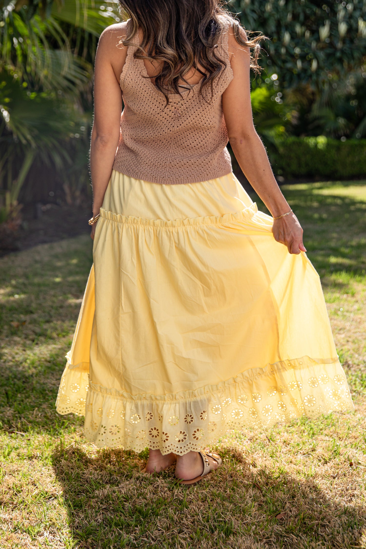 Yellow lace-trim maxi skirt styled outdoors