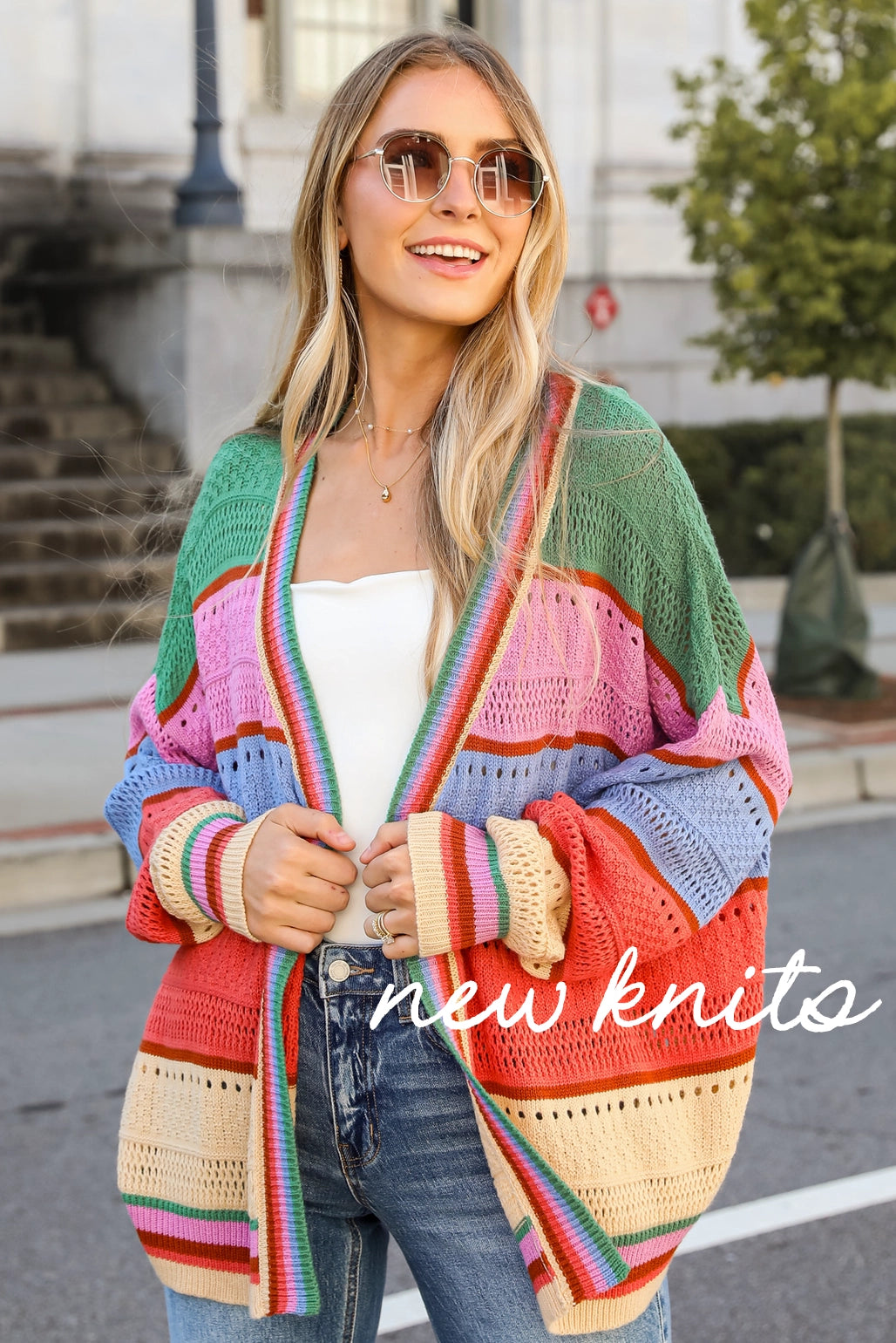 model wearing striped knit cardigan layered with white tank