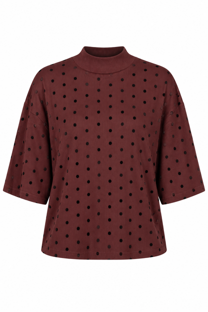 A dark brown mock neck top with black polka dots, featuring elbow-length sleeves, shown against a plain white background.