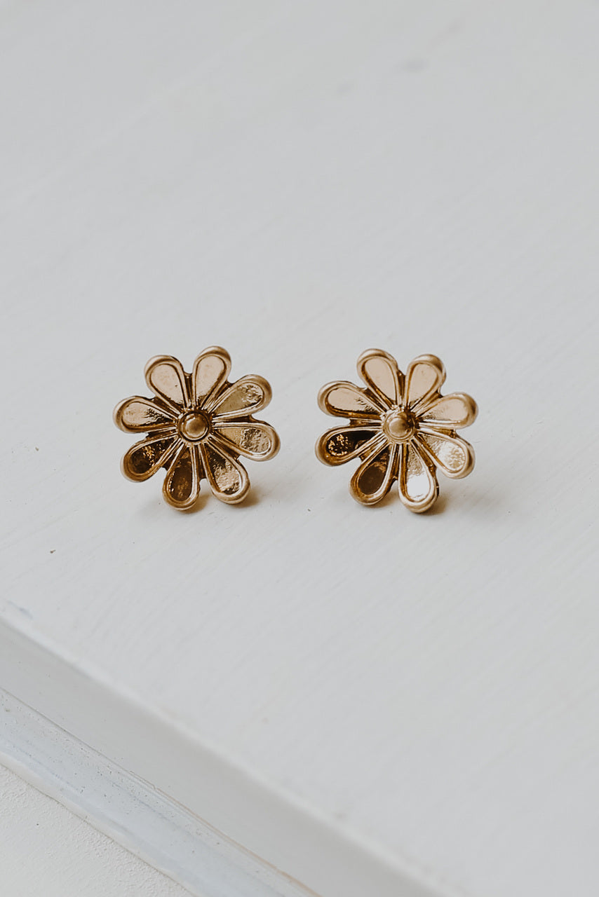 flat lay of gold flower earrings