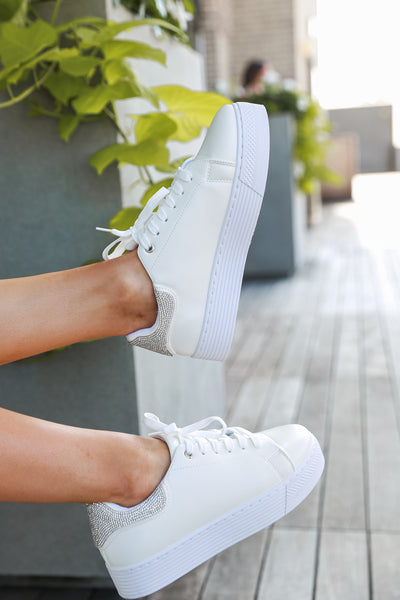model wearing white sneakers