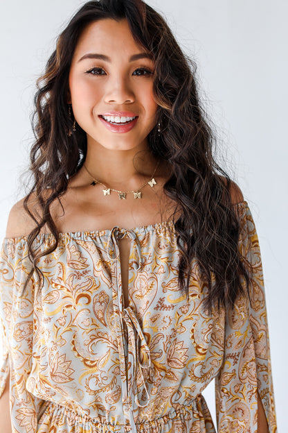 close view of model wearing paisley romper