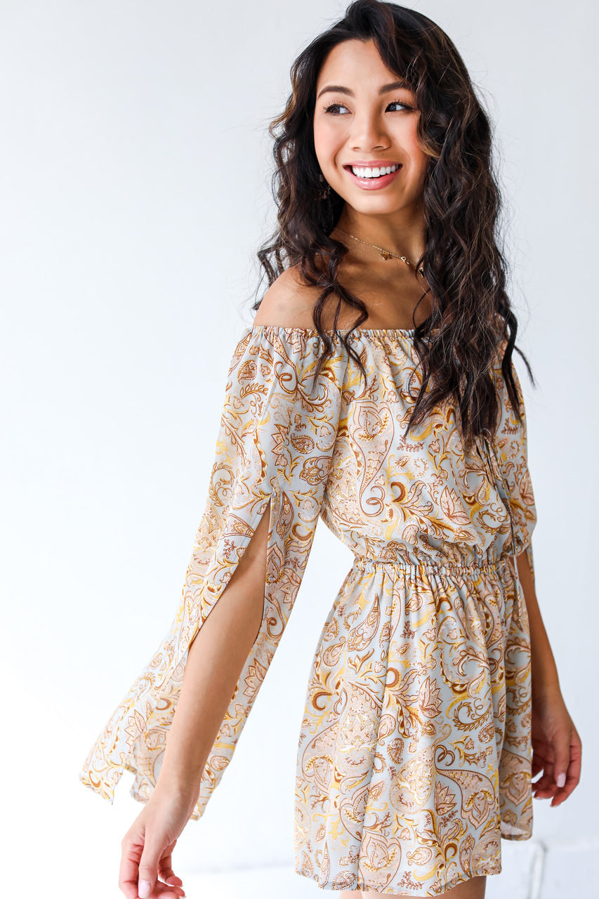 side view of model wearing paisley romper