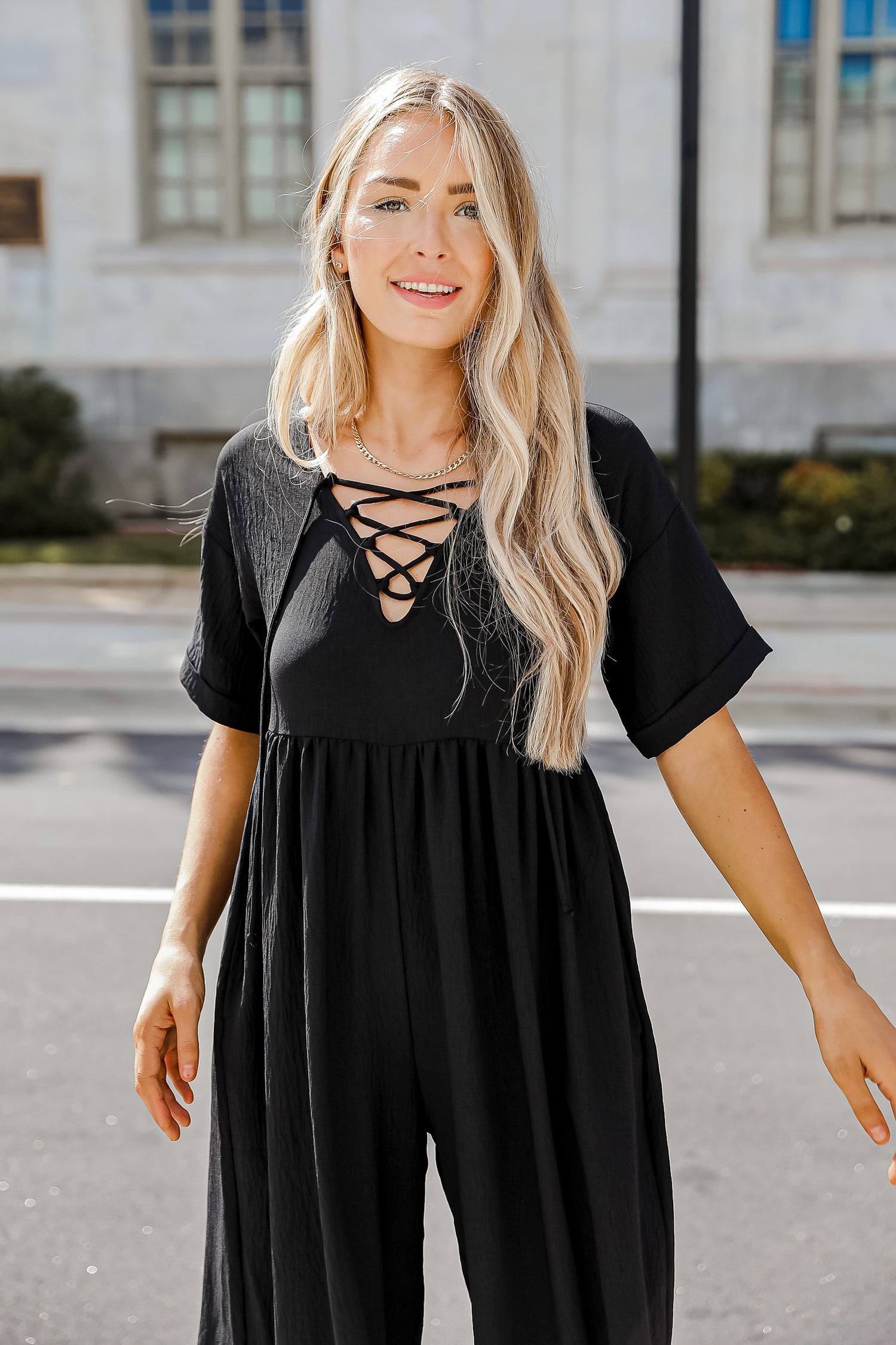 black jumpsuit on model with front laces