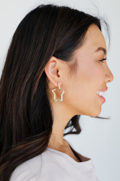 Gold Star Hoop Earrings on model