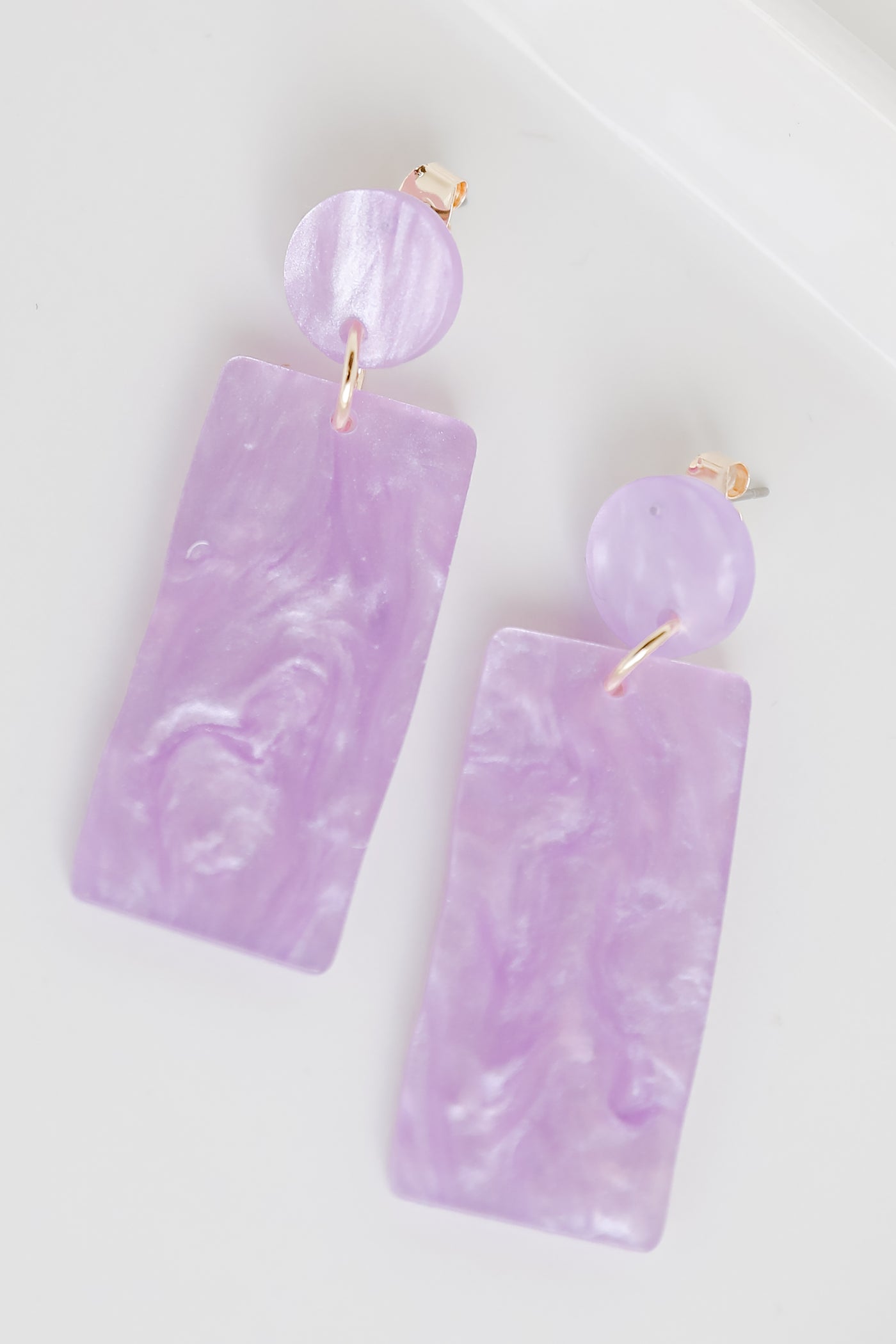 Acrylic Statement Earrings in purple flat lay
