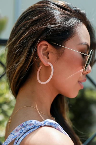 Acrylic Hoop Earrings in blush on model