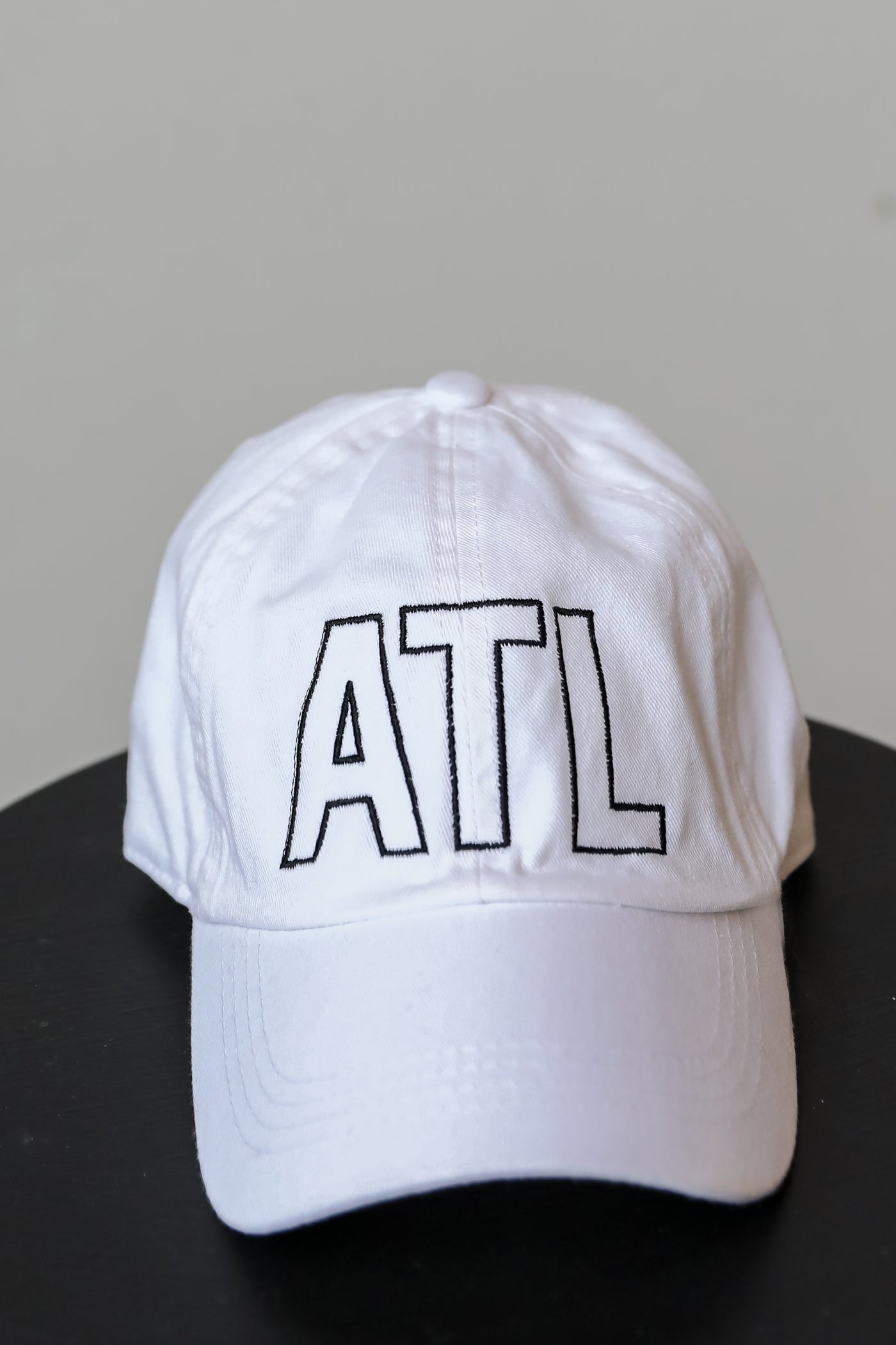 flat lay of a ATL Vintage Embroidered Hat in white