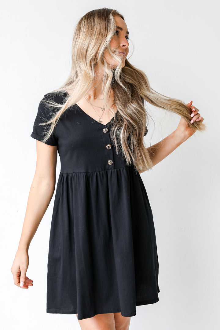 Button Front Babydoll Dress in black on model