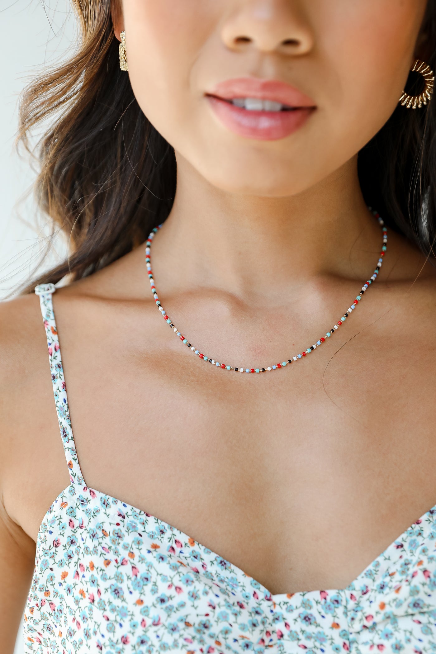model wearing a dainty beaded necklace