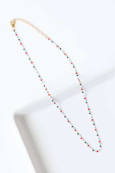 multi colored beaded necklace flat lay