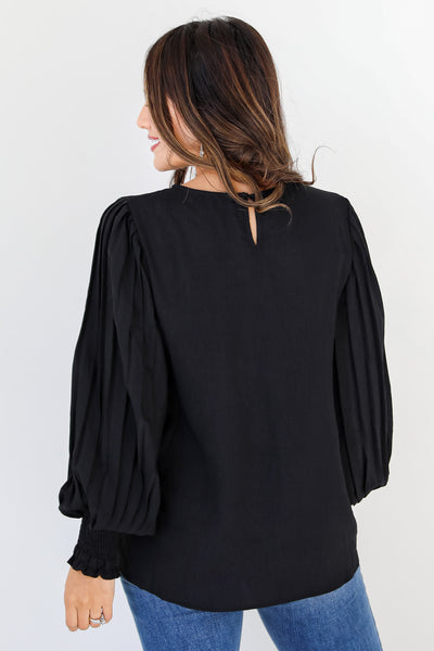 black pleated sleeve blouse back view