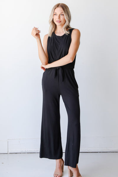 model wearing a black Jumpsuit with heels