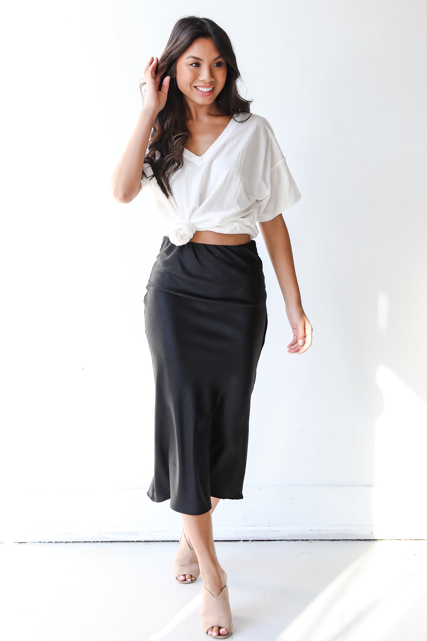 model wearing a black midi skirt