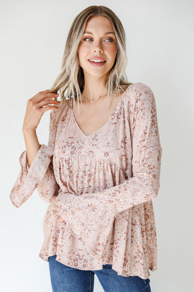 model wearing a pink floral blouse