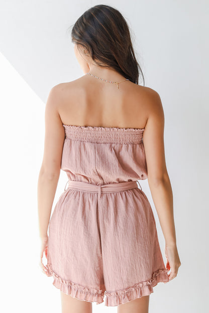back view of a pink strapless romper