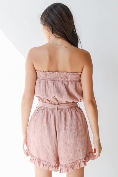 back view of a pink strapless romper