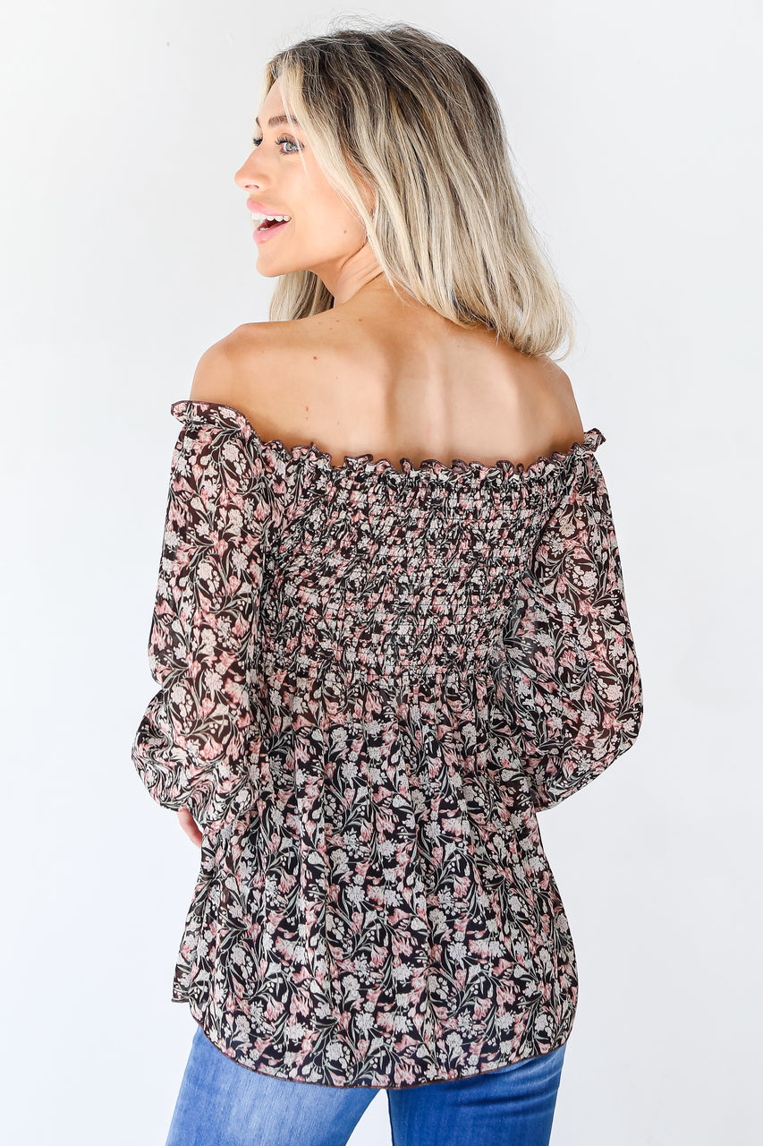 back view of model wearing floral smocked blouse 