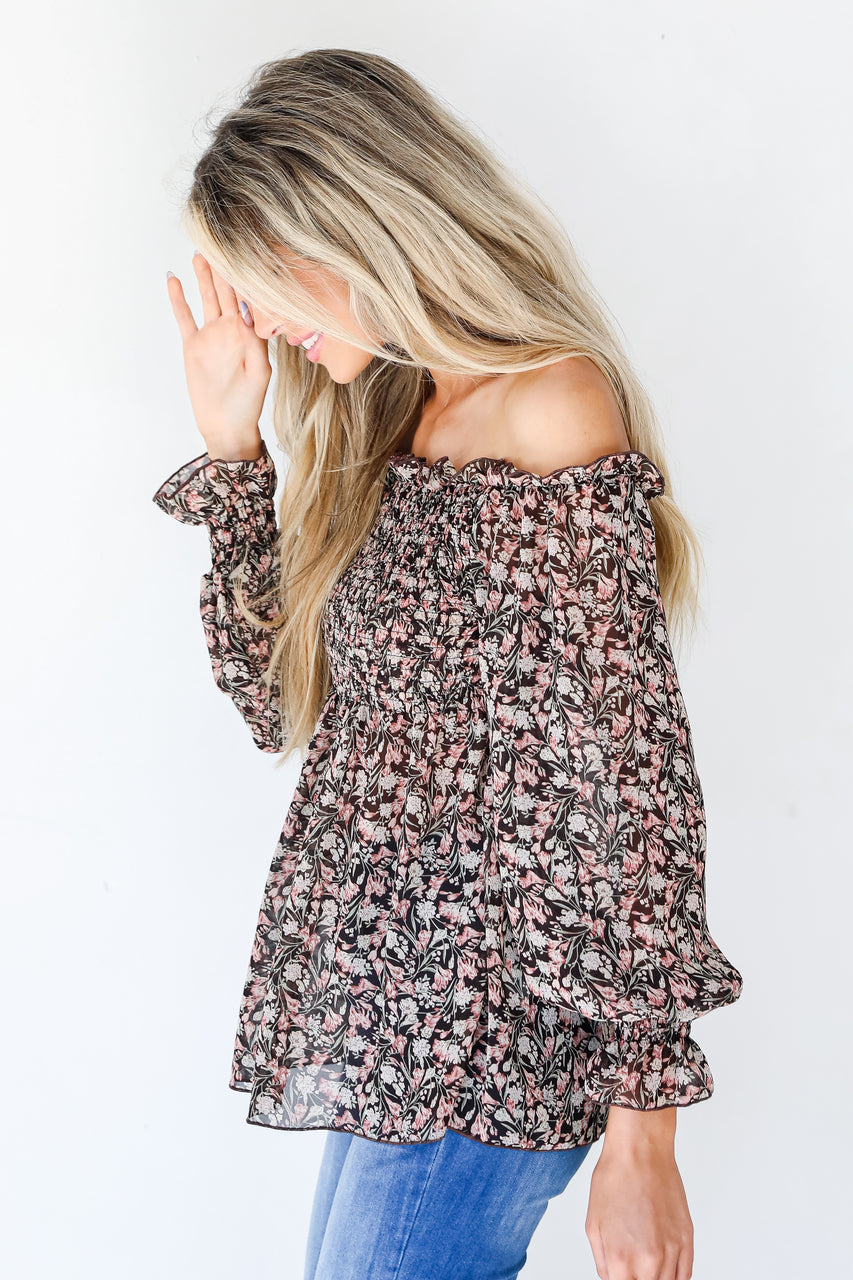 side view of model wearing floral smocked blouse 