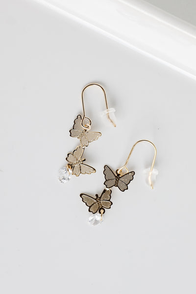 Gold Butterfly Drop Earrings flat lay