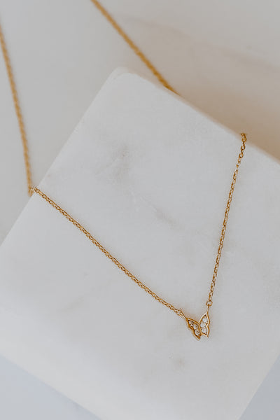 flat lay of a Gold Rhinestone Butterfly Necklace