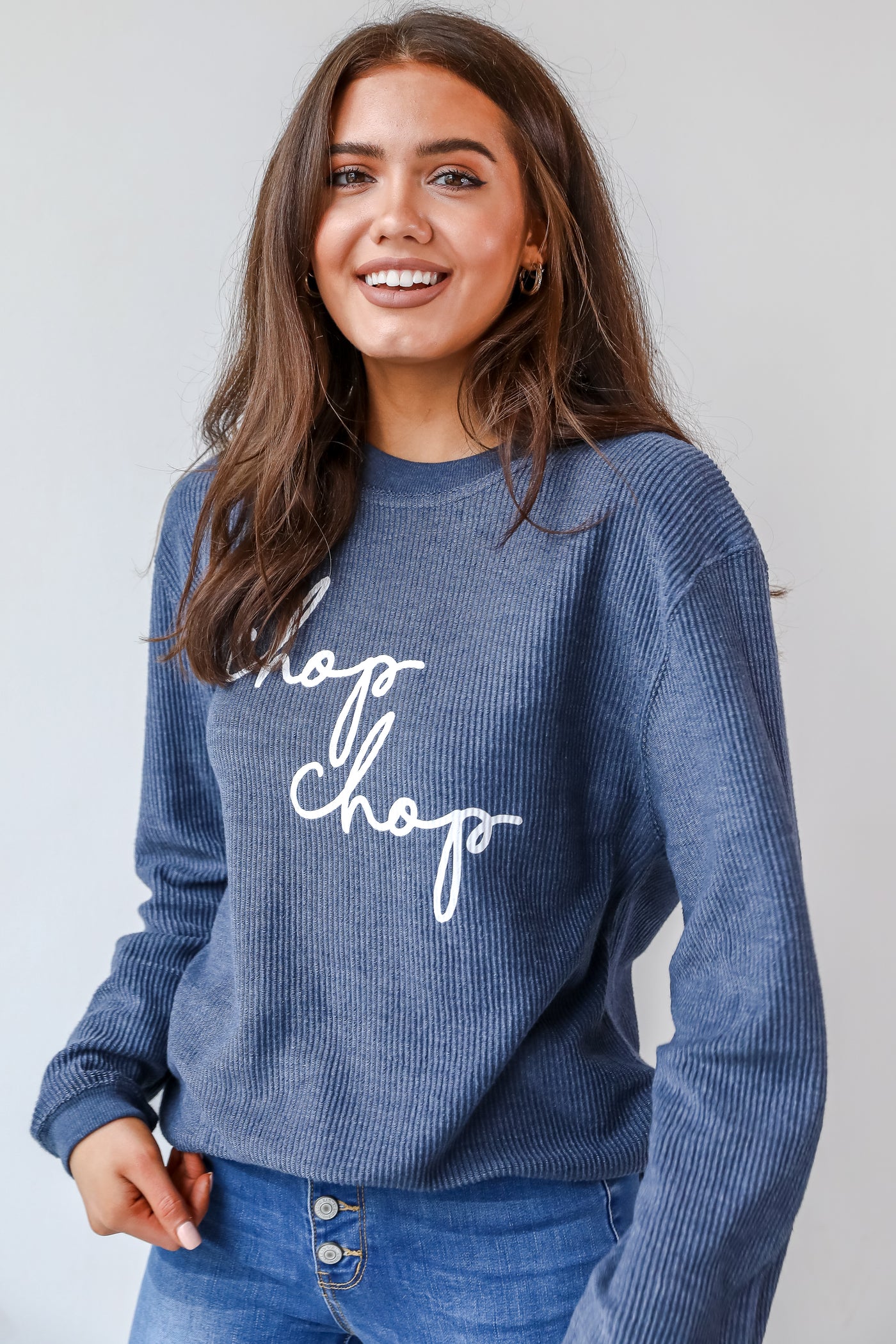 This comfy sweatshirt is designed with a soft and stretchy corded knit. It features a crew neckline, long sleeves, an oversized fit, and the words "Chop Chop" on the front.