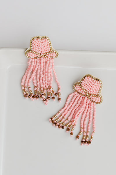 flat lay of pink Cowgirl Hat Beaded Fringe Earrings