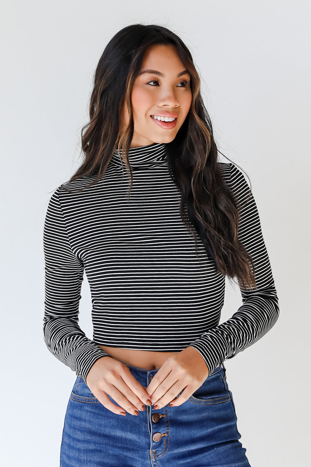 model wearing black and white striped mock neck basic top