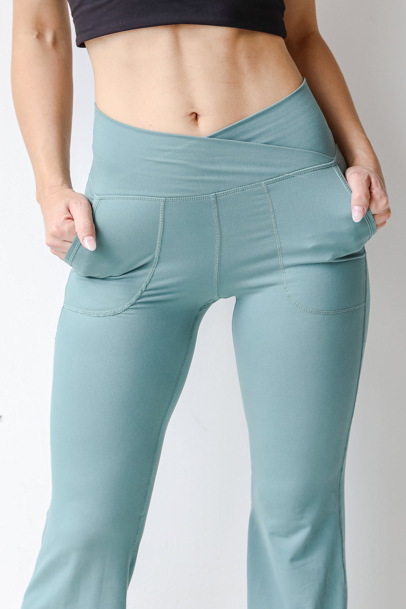 Crossover Flared Leggings in teal close up