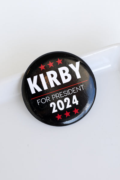 black Kirby For President Button flat lay