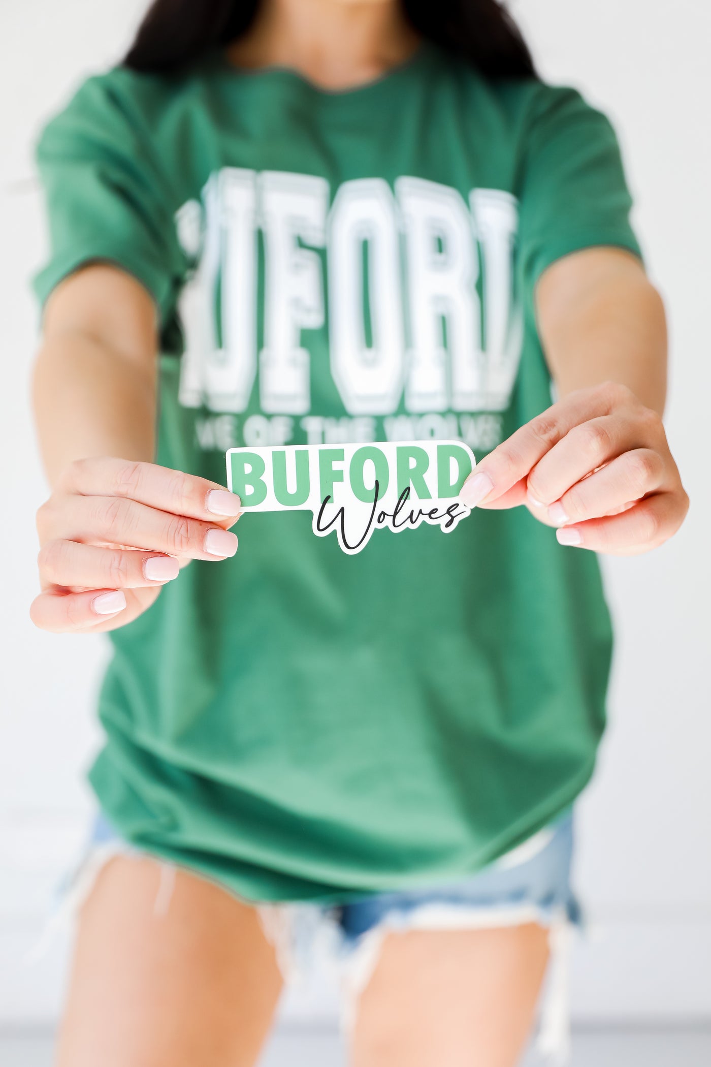 model holding the Buford Wolves Sticker