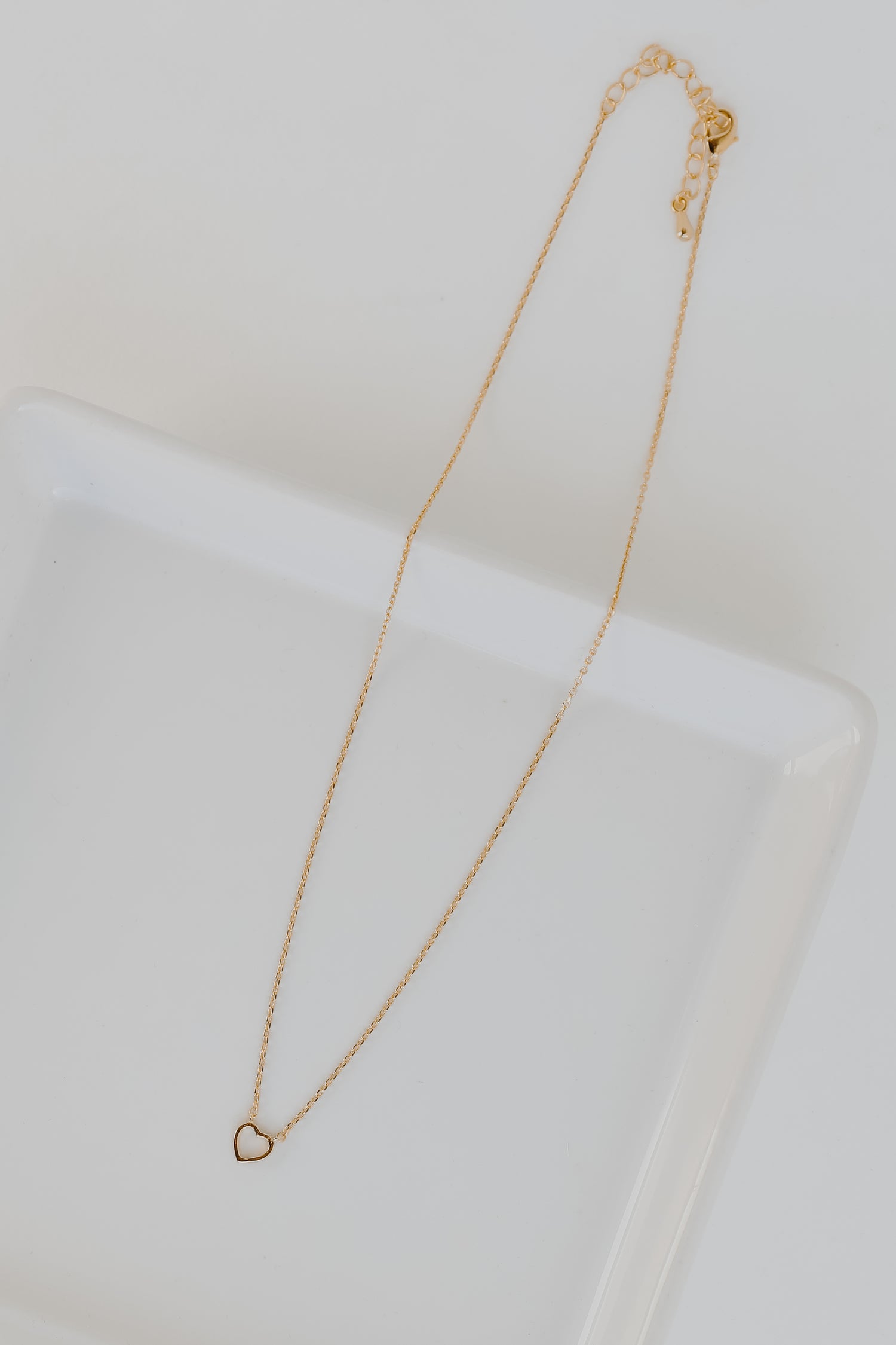 Gold Heart Charm Necklace flat lay
