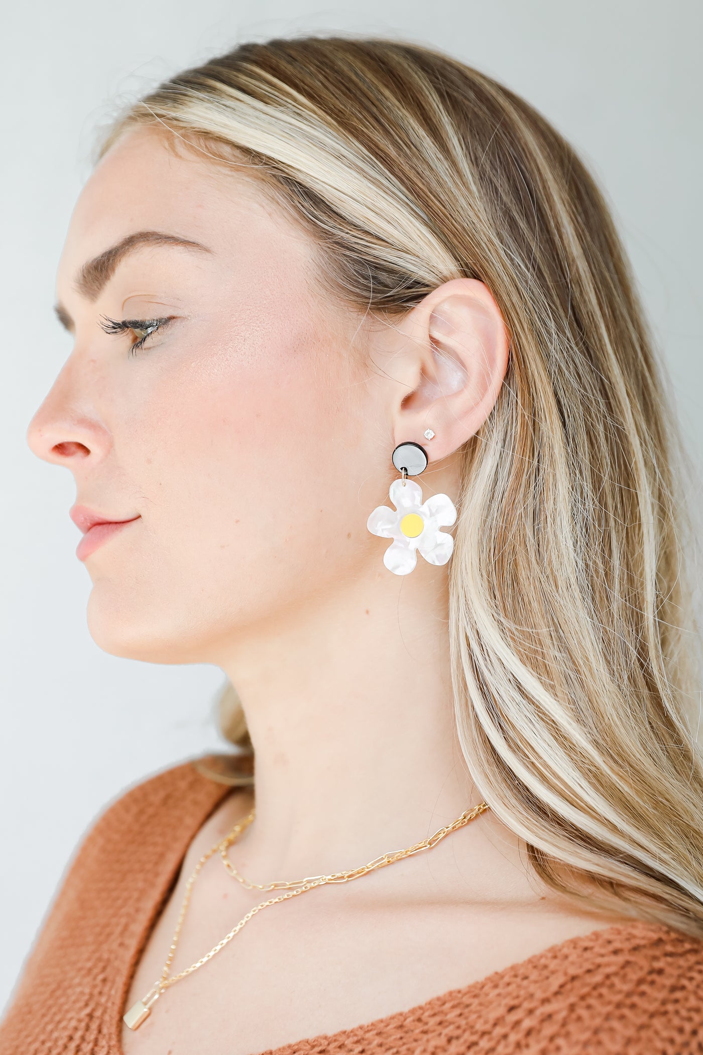 model wearing acrylic daisy earrings