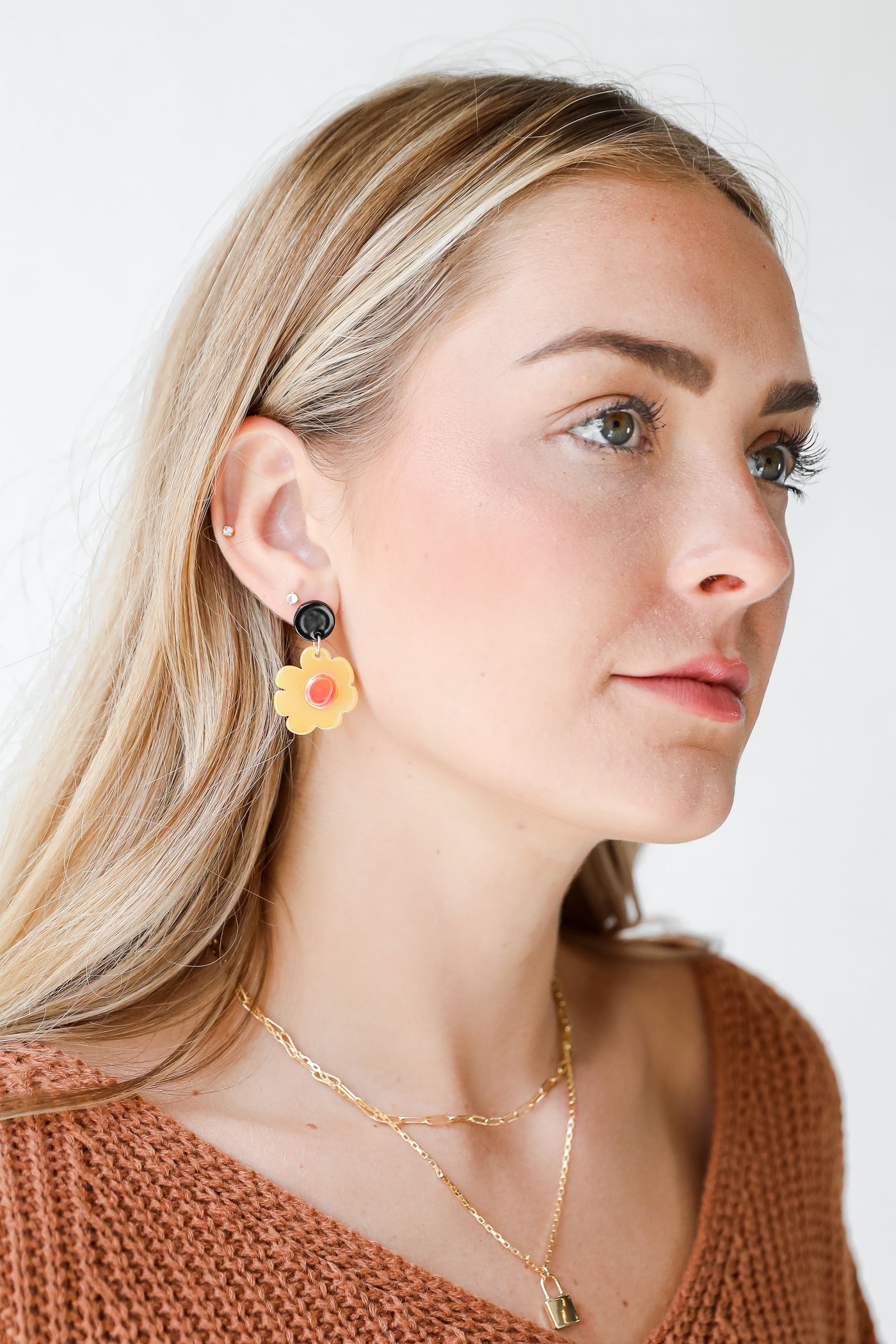 model wearing yellow flower earrings