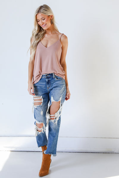 model wearing blush tank and distressed denim jeans with booties