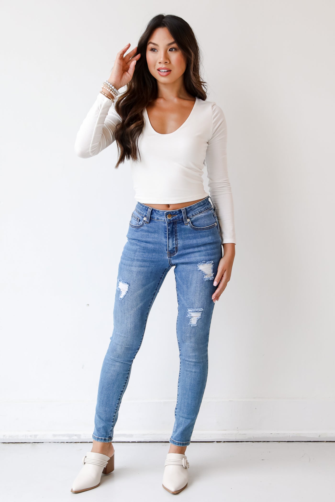 medium wash skinny jeans on model