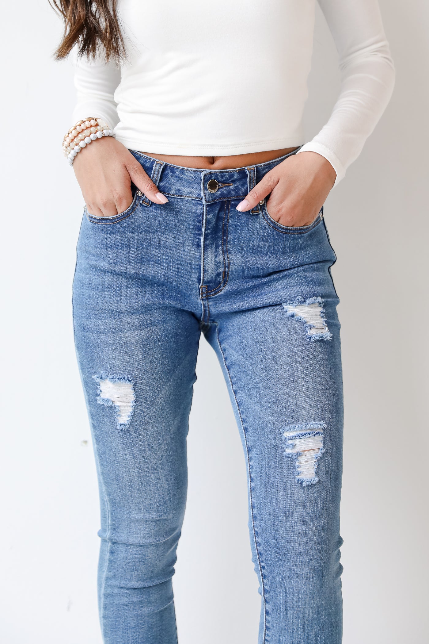 medium wash skinny jeans close up