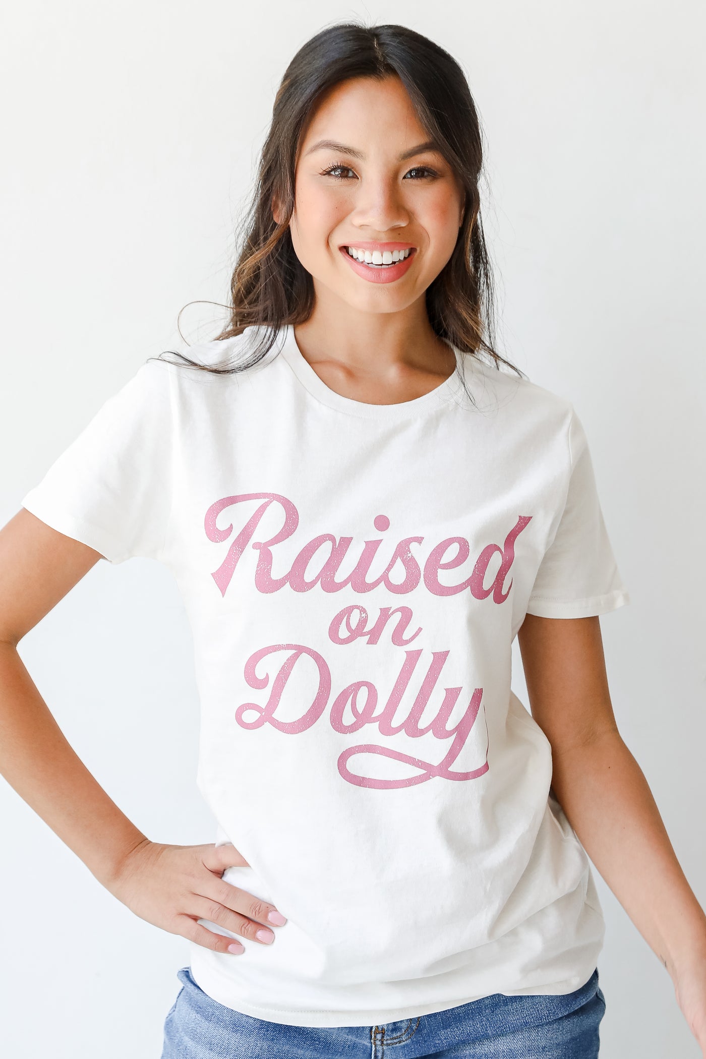 model wearing a Raised On Dolly Tee with denim