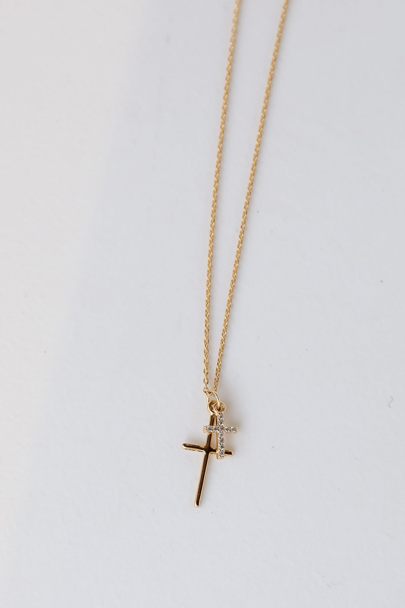 Gold Cross Charm Necklace flat lay