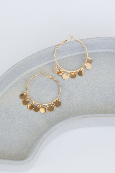 Gold Circle Charm Earrings flat lay