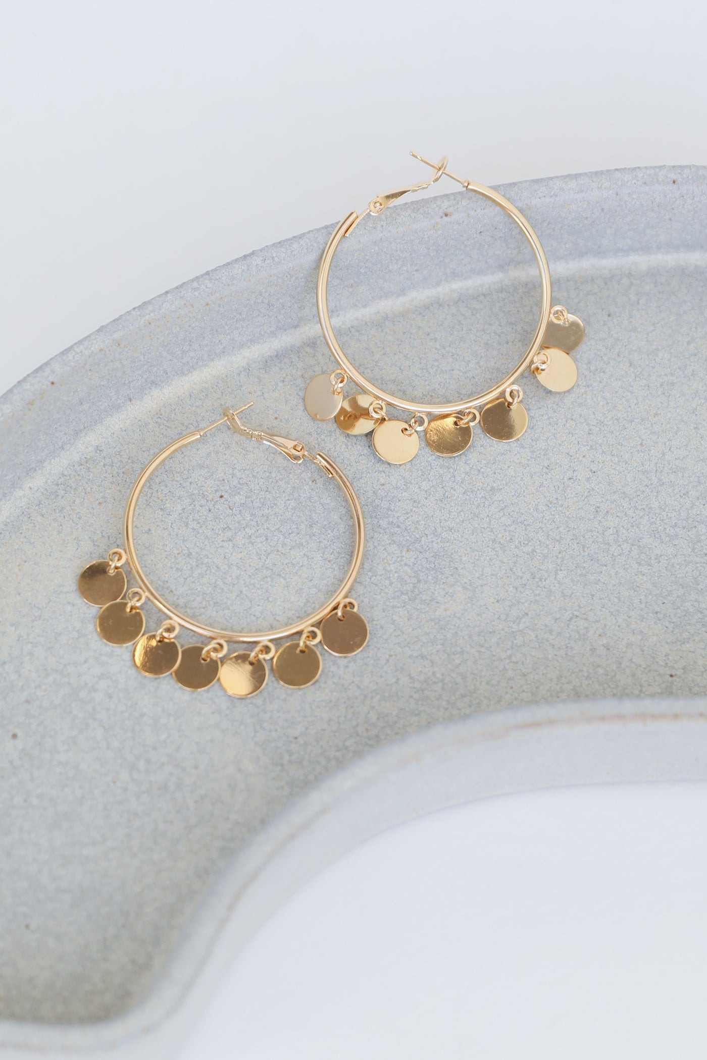 Gold Circle Charm Earrings flat lay