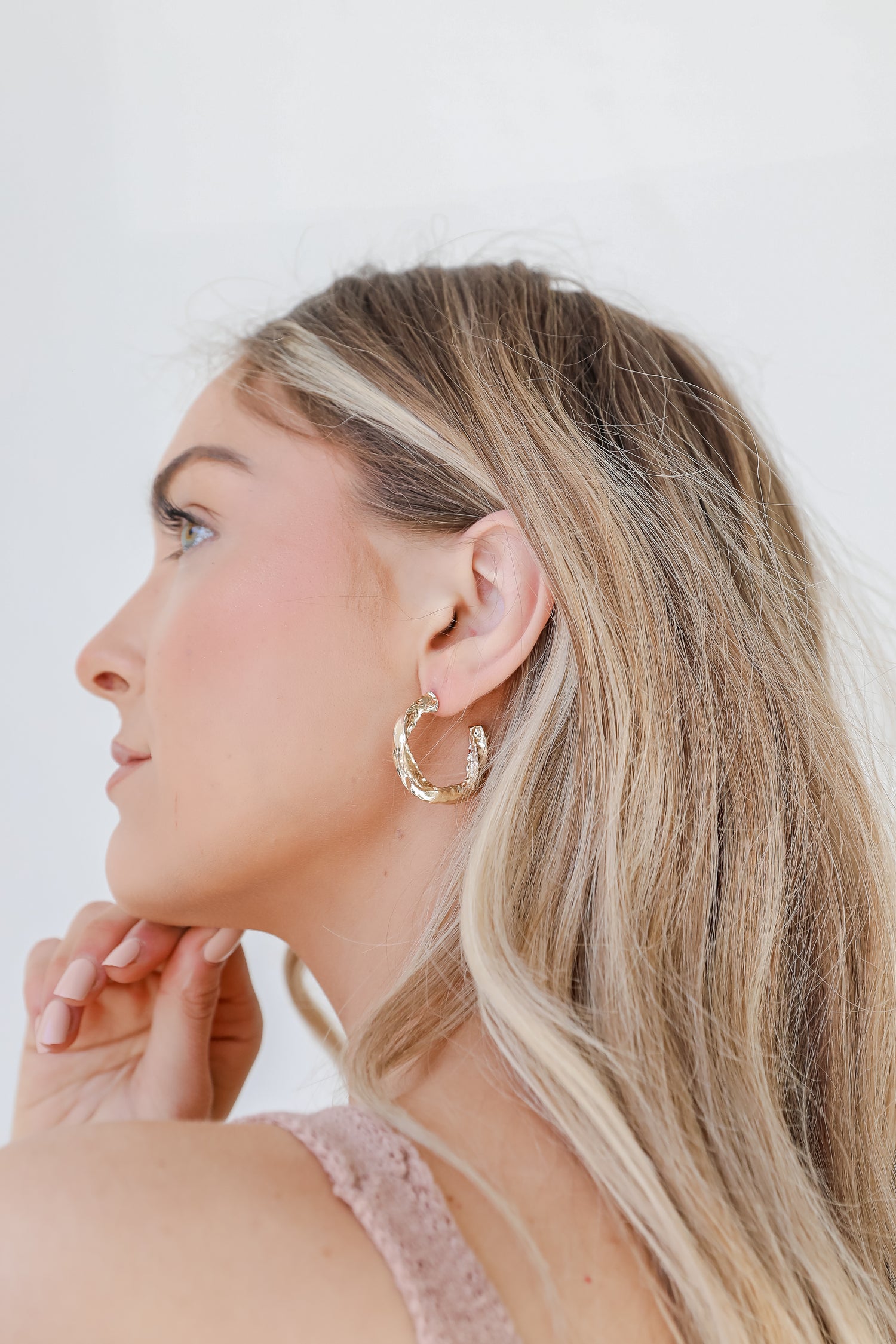 Gold Hammered Hoop Earrings on model
