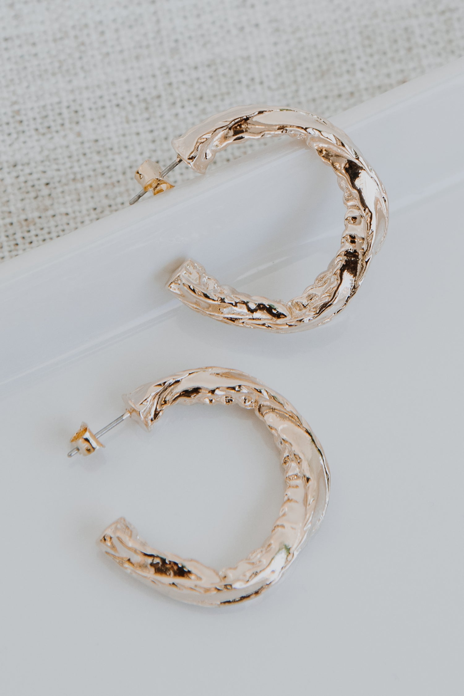 Gold Hammered Hoop Earrings flat lay