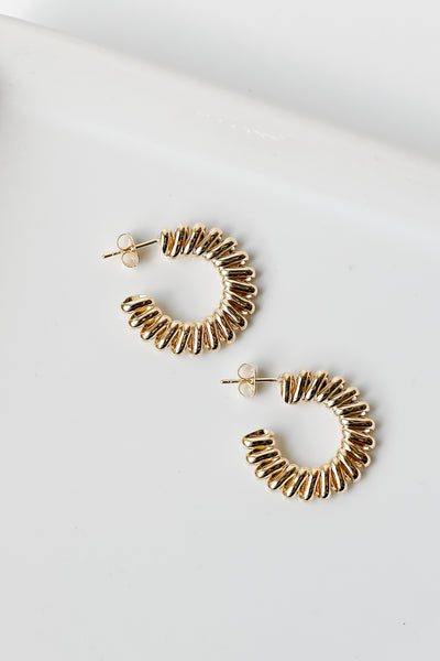 flat lay of gold coil hoops